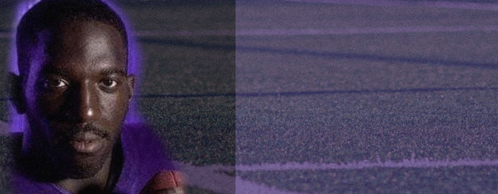 A close-up of a person wearing a purple shirt at a community event in Augusta