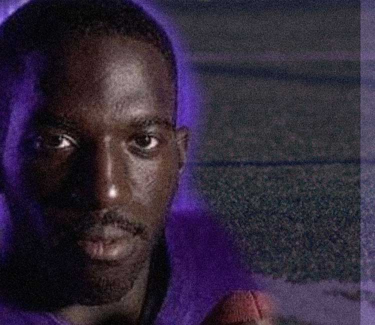 A close-up of a person wearing a purple shirt at a community event in Augusta